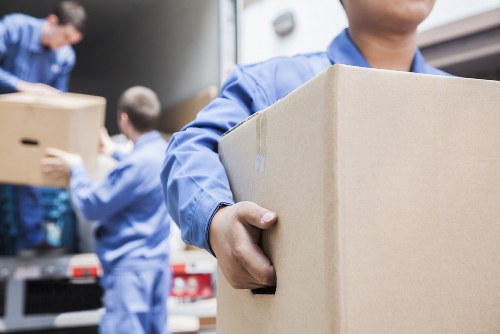 Student removals team handling boxes in a Wimbledon residential street