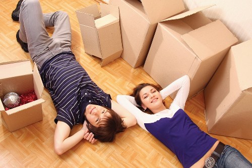 Specialist movers handling a piano in a Wimbledon property with narrow access