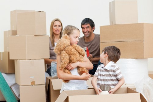 Local removalists handling furniture and boxes in a Wimbledon property with stairs